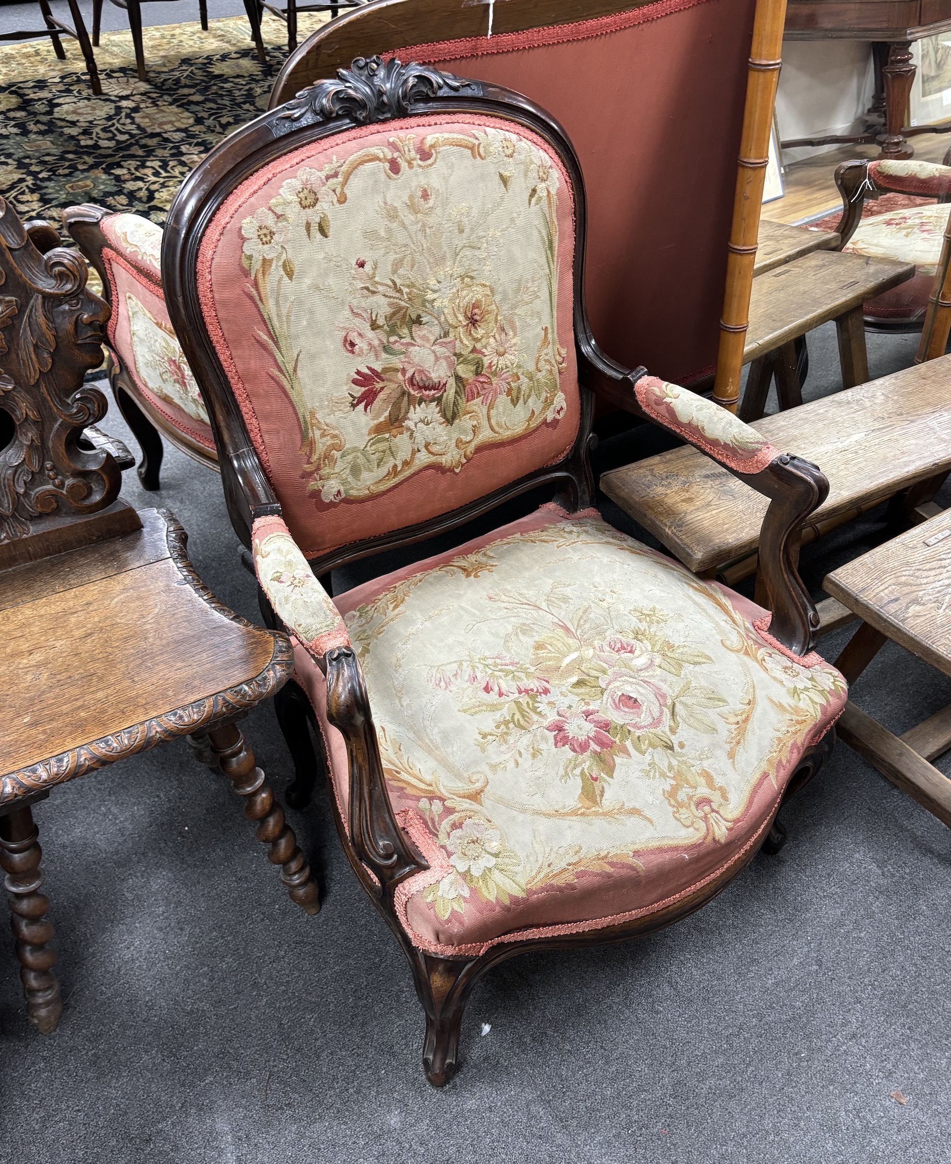 A pair of 19th century French rosewood open armchairs with floral needlepoint upholstery, width 66cm, depth 54cm, height 94cm